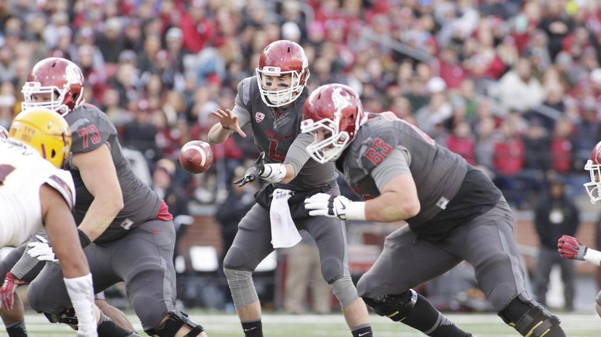 Washington State quarterback Luke Falk (4) takes a snap as offensive linemen Eduardo Middleton (73) and Gunnar Eklund (63) prepare to block during the first half of an NCAA college football game against Arizona State, Saturday, Nov. 7, 2015, in Pullman, Wash. (AP Photo/Young Kwak)