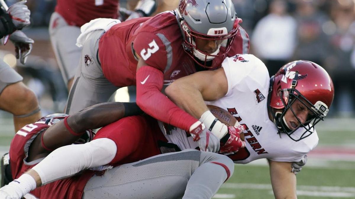 EWU wide receiver Cooper Kupp, right, is brought down by Washington State defensive back Darrien Molton (3) and defensive back Trey Tinsley (10) during the first half. Kupp caught 12 passes for 206 yards and three touchdowns.