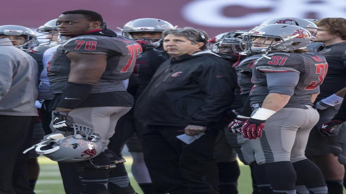 
Washington State head coach Mike Leach, center, plus offensive lineman Rico Forbes (76) and defensive back Parker Henry (31) look at a scoreboard video replay during the first half timeout against Utah in an NCAA college football game Saturday, Nov. 23, 2013, at Martin Stadium in Pullman, Wash. (AP Photo/Dean Hare)

