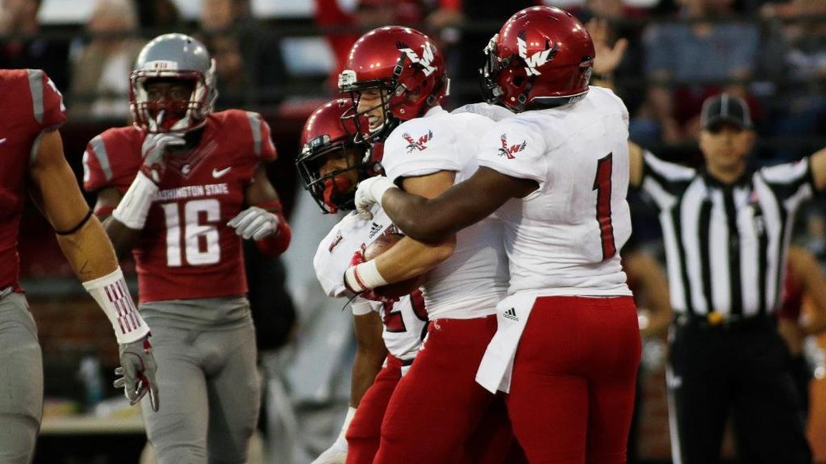 After scoring a touchdown, Eastern Washington wide receiver Cooper Kupp, center, celebrates with wide receiver Shaq Hill (1) and running back Antoine Custer Jr. during the second half of an NCAA college football game against Washington State in Pullman, Wash., Saturday, Sept. 3, 2016. Eastern Washington won 45-42.