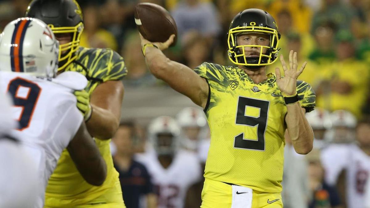 Oregon’s Dakota Prukop, right, throws down field against Virginia during the third quarter of an NCAA college football game Saturday, Sept. 10, 2016 in Eugene, Ore.