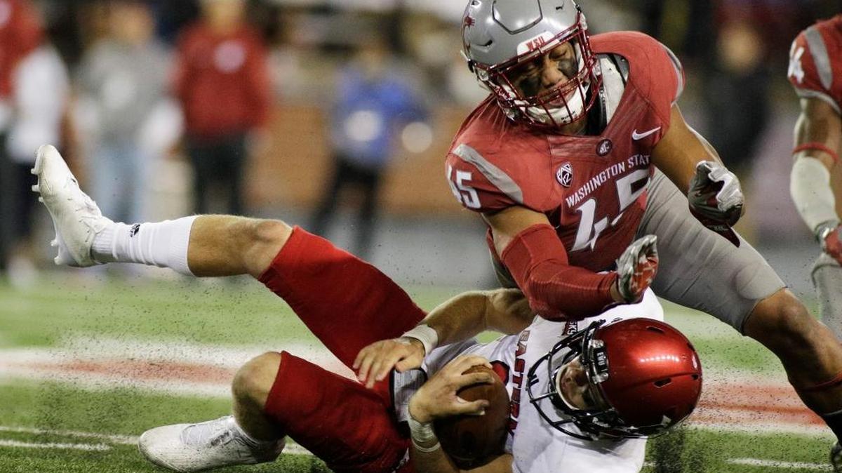 Washington State linebacker Logan Tago (45) brings down Eastern Washington quarterback Gage Gubrud during the second half of an NCAA college football game in Pullman, Wash., Saturday, Sept. 3, 2016.