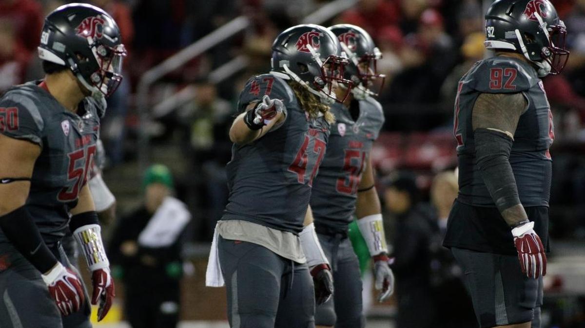 Washington State defensive end Hercules Mata'afa (50), linebacker Peyton Pelluer (47), linebacker Frankie Luvu (51) and nose tackle Robert Barber (92) stand on the field during the second half of an NCAA college football game against Oregon in Pullman, Wash., Saturday, Oct. 1, 2016.