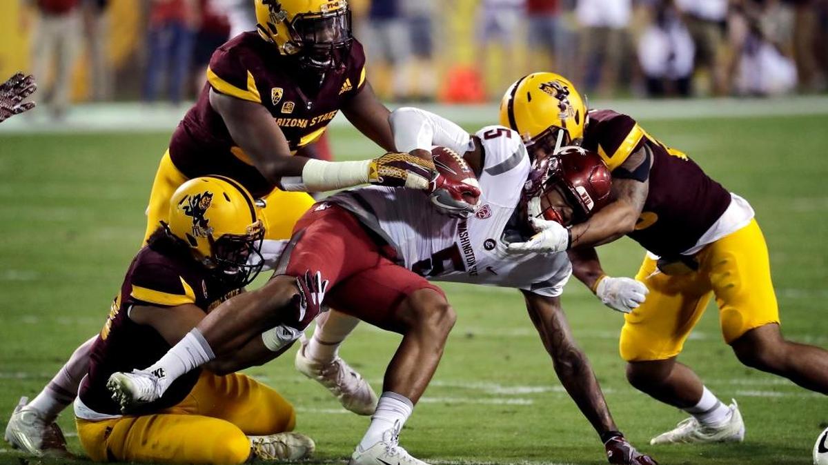 Washington State wide receiver Isaiah Johnson-Mack (5) is hit by Arizona State defensive lineman Edmond Boateng, left rear, and linebacker Salamo Fiso, left front, during the first half of an NCAA college football game, Saturday, Oct. 22, 2016, in Tempe, Ariz.