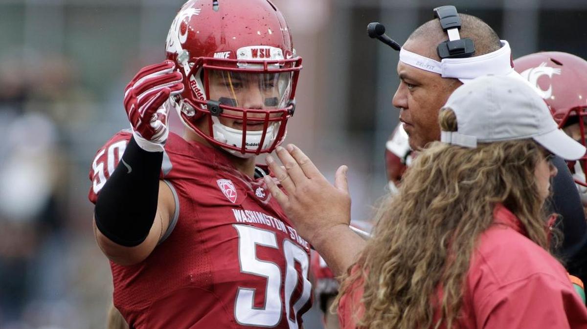 Washington State defensive end Hercules Mata'afa speaks with assistant head coach and defensive line coach Joe Salave'a during the second half of a game against Idaho in Pullman, Wash. on Sept. 17, 2016.