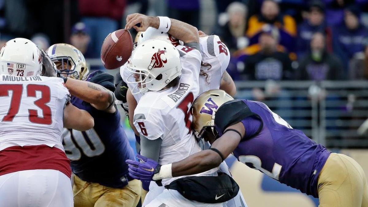 Washington State quarterback Peyton Bender (6) loses the ball while being hit by Washington's Cory Littleton in the second half of an NCAA college football game Friday, Nov. 27, 2015, in Seattle.