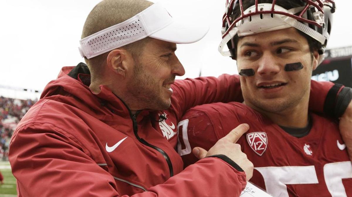 Washington State defensive coordinator Alex Grinch speaks with defensive lineman Hercules Mata'afa after the Cougars’ 24-21 win over Stanford in Pullman, Wash., on Nov. 4, 2017.