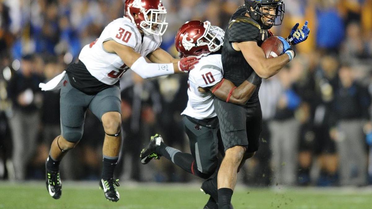 UCLA receiver Jordan Payton is brought down by Washington State’s Kirkland Parker (10) and Taylor Taliulu (30) during a college football game at the Rose Bowl in Pasadena, Calif., on Saturday, Nov. 14, 2015.