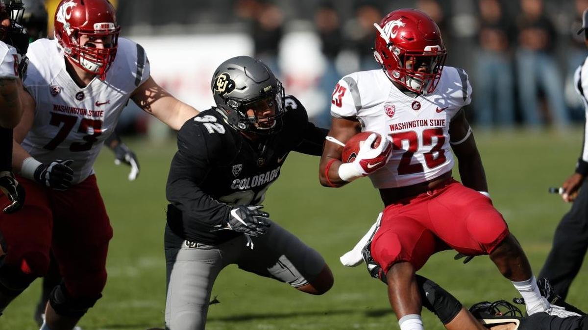 Washington State running back Gerard Wicks (23) looks for an opening against Colorado linebacker Rick Gamboa (32) in the first half of an NCAA college football game Saturday, Nov. 19, 2016, in Boulder, Colo.