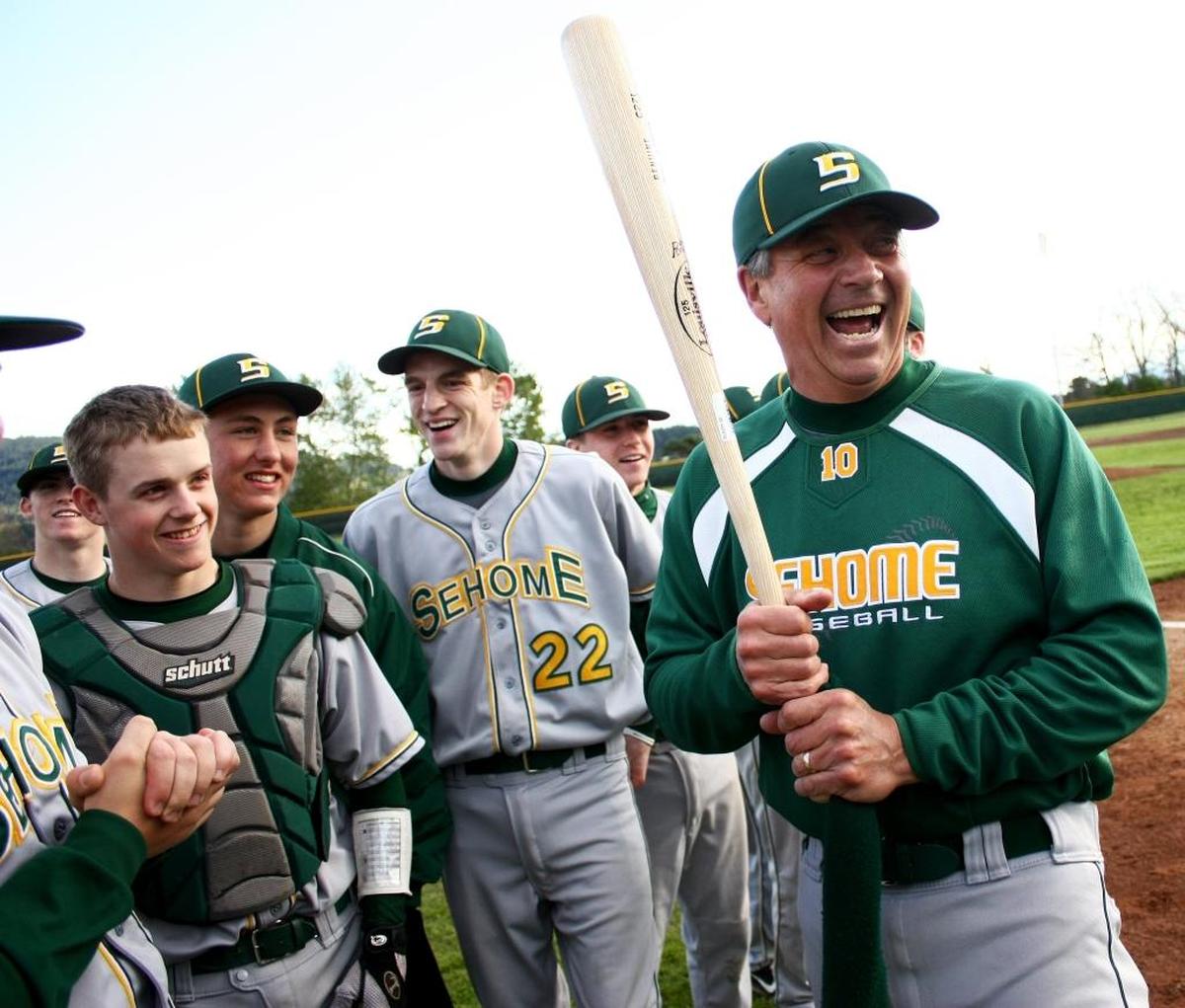 Sehome's head coach Gary Hatch laughs with his team after Sehome beat Squalicum 3-0 in baseball on Monday April 30, 2012 in Bellingham. Hatch was honored Monday night after he reached 500 victories in a victory over Ferndale on Friday April 27, 2012.