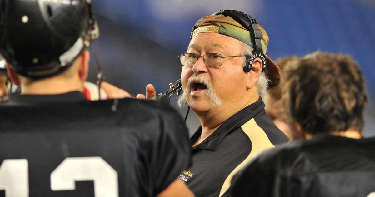 Meridian head coach Bob Ames talks with his players during a timeout as the Meridian Trojans lost 21-0 to the Cascade Christian Cougars in a 1A state football semifinal game Saturday November 27, 2010 at the Tacoma Dome in Tacoma, Wa.