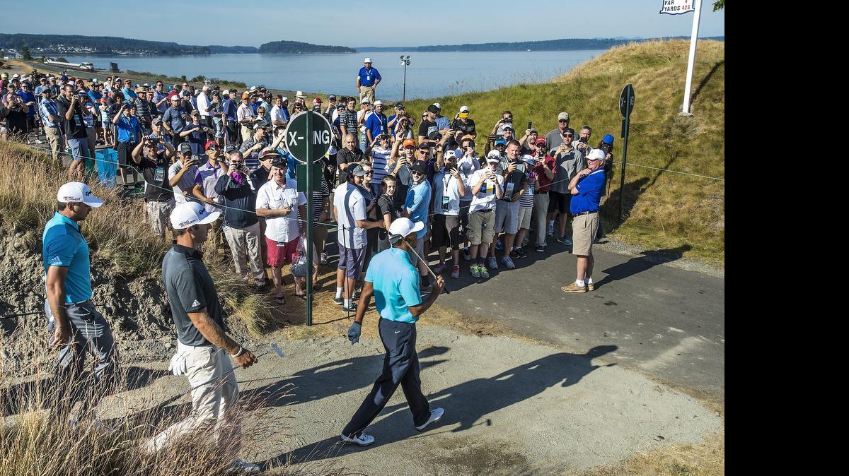 
Tiger Woods draws a crowd Monday as he gets in a practice round at Chambers Bay golf course before the U.S. Open starts Thursday. Woods hasn’t won a major title since the 2008 U.S. Open at Torrey Pines.
