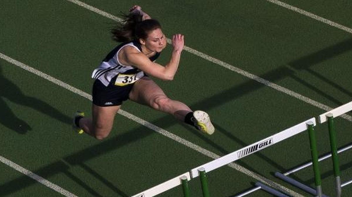 Lynden Christian’s Hannah Rusnak clears a hurdle during the girls’ 100 meter hurdles at the Bedlington Twilight Invitational track meet on Friday, March 25, at Lynden High School. Rusnak is one of many Whatcom County athletes that will be competing in the State Track and Field Championships this weekend.