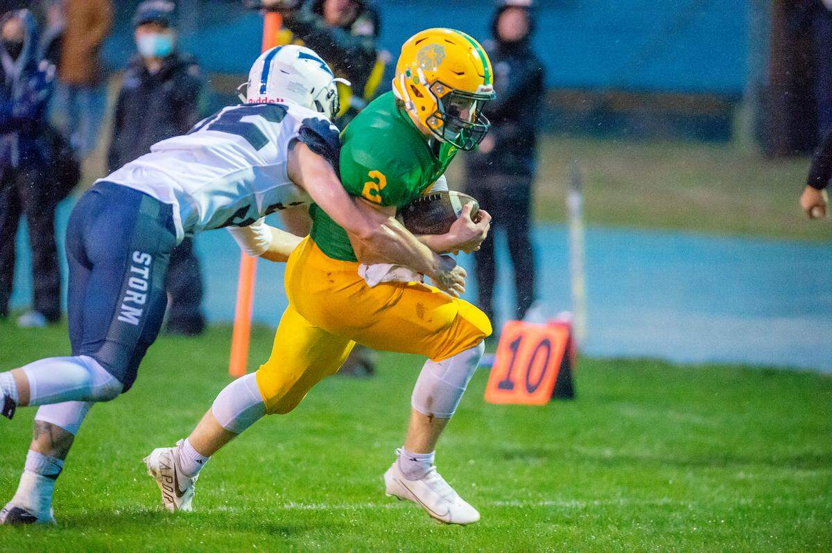 Squalicum linebacker Jaymeson Thompson (32) wraps up Lynden running back Campbell Nolte (2) as he rounds the corner while eyeing the goal line during the first quarter at Lynden High School on Friday evening, Sept. 17, in Lynden. Nolte was stopped just short of the goal as Lynden went on to defeat Squalicum 15 to 12.