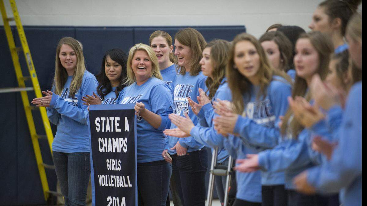 Lynden Christian's volleyball team celebrates winning the state championship with a banner hanging ceremony at halftime of a basketball game between Blaine and Lynden Christian on Thursday, Jan. 29, 2015 at Lynden Christian High School.