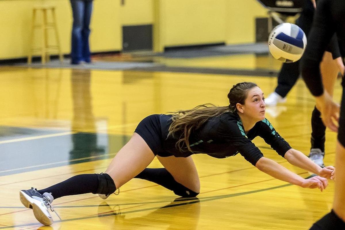 Lynden’s Savonne Sterk dives to save a return from Blaine during a winner-to-state match of the 2A bi-district tournament Nov. 4. The Lions face North Kitsap in the first round of the Class 2A State Tournament Friday in Lacey.