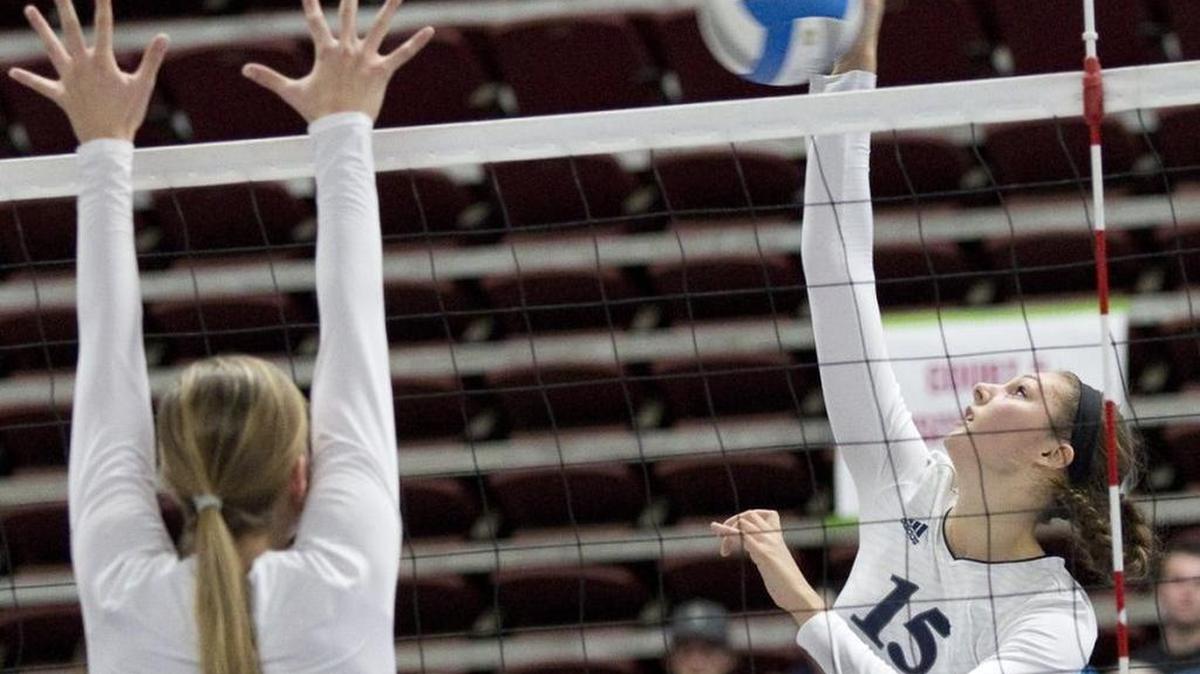 Lynden Christian’s Kara Bajema (15) spikes over Cedar Park Christian’s Madysen Trout (11) in the Class 1A State Volleyball Final Saturday, Nov. 14, at the Yakima Valley SunDome. Lynden Christian defeated Cedar Park Christian in straight sets to repeat at state champions.