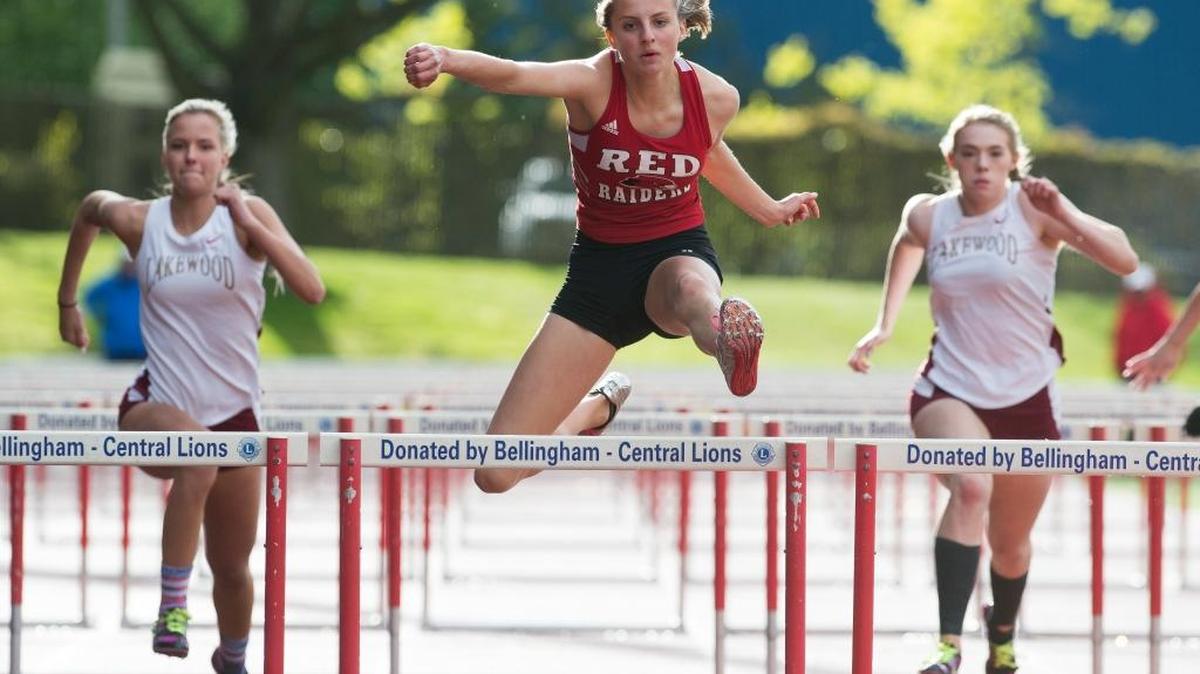 Bellingham’s Claire Campbell, center, runs to a first-place finish in the 100 meter hurdles at the NWC 2A Sub-District Track Meet on Friday, May 12 at Civic Field in Bellingham, Wash.