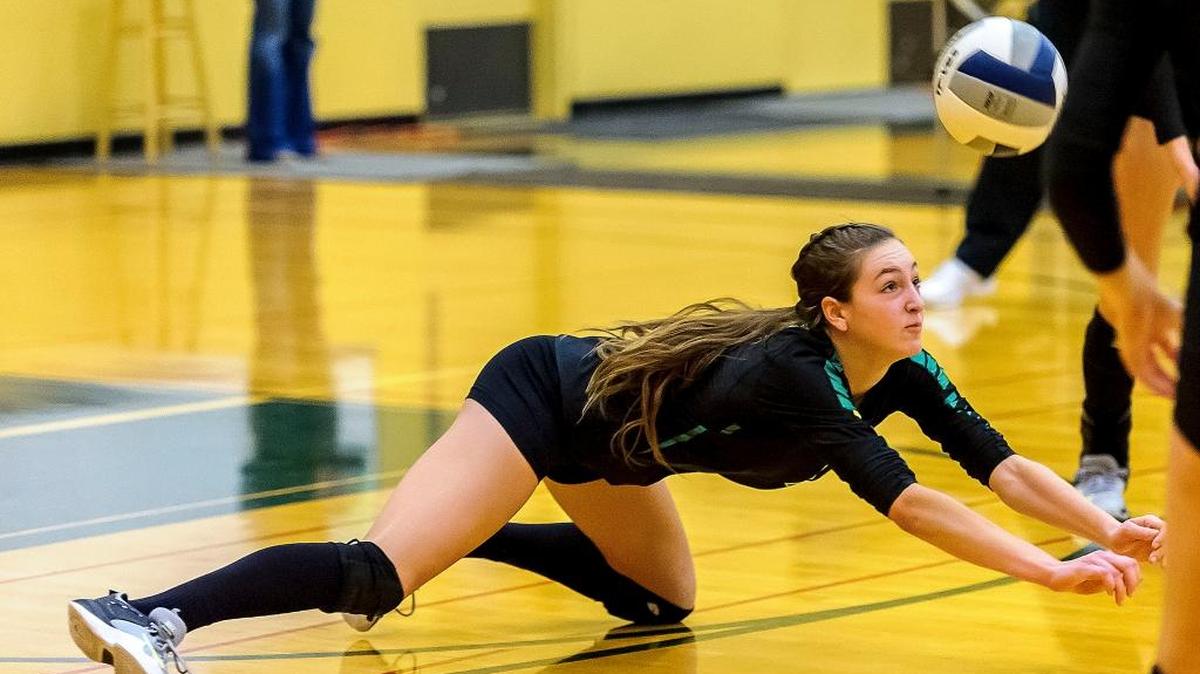 Lynden’s Savonne Sterk (12) dives to save a return from Blaine during the third game in the 2A bi-district volleyball tournament Saturday, Nov. 4, at Lynden High School.