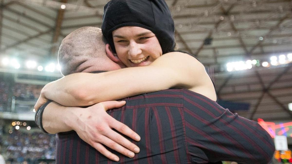 Mount Baker's Natalie Smith hugs her coach Clyde Blockley after winning the girls' 125-pound state championship at Mat Classic XXVIII at the Tacoma Dome.
