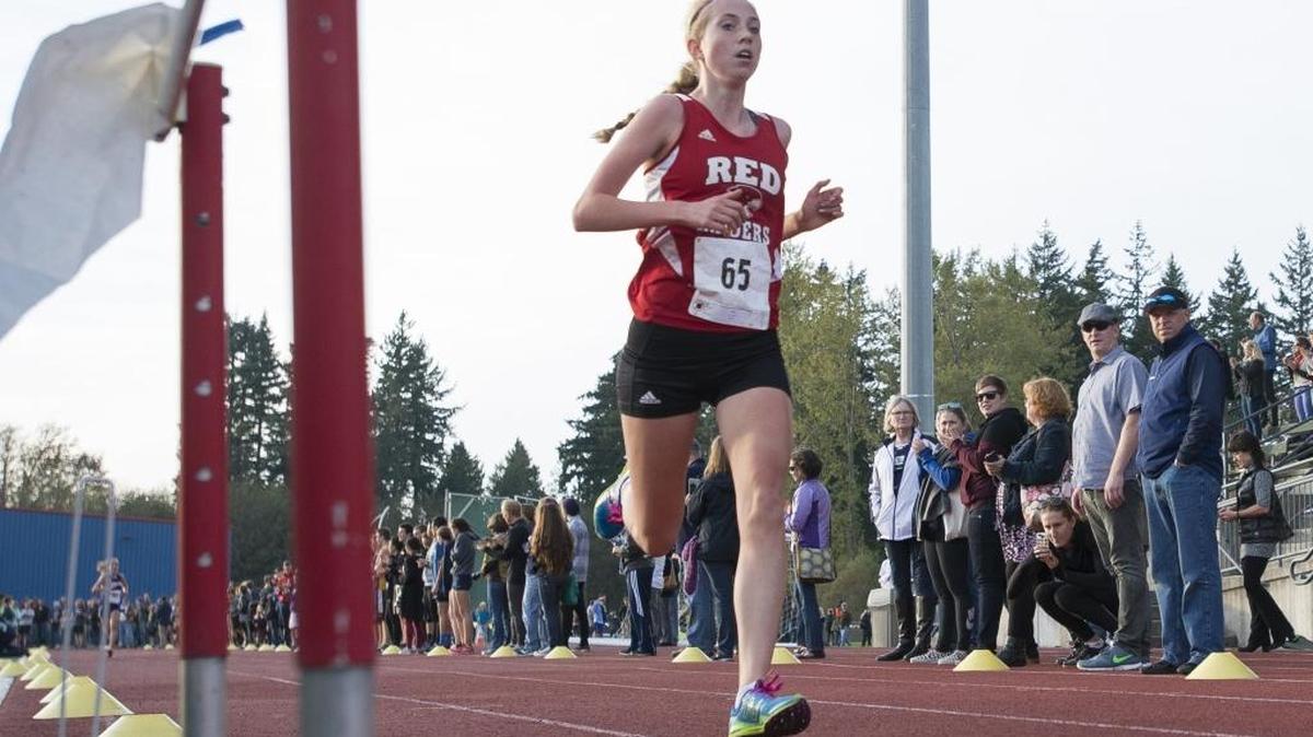 Bellingham’s Annika Reiss cross the finish line first during the girls’ varsity race at the 2015 NWC Cross Country Championships Oct. 22, at Civic Stadium.