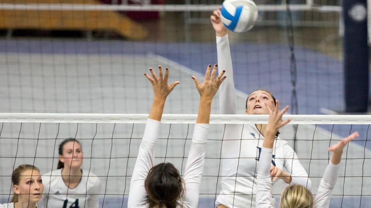 Lynden Christian’s Kara Bajema (15) spikes over Cedar Park Christian’s Tess Biscup (7) and Albina Melnik (2) in the Class 1A State Volleyball Final on Saturday, Nov. 14, at the Yakima Valley SunDome. Lynden Christian defeated Cedar Park Christian in straight sets to repeat as state champions.