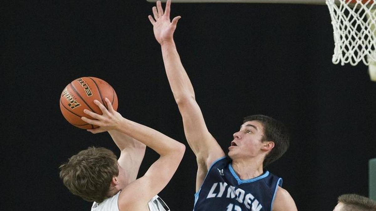 Lynden Christian’s Josiah Meppelink defends a shot by Zillah’s Trey Delp in a Class 1A State Tournament semifinal game on Friday, March 6, at the Yakima Valley SunDome in Yakima, Wash. The state may adopt a ranking formula to determine playoffs seeds in 2016-17.