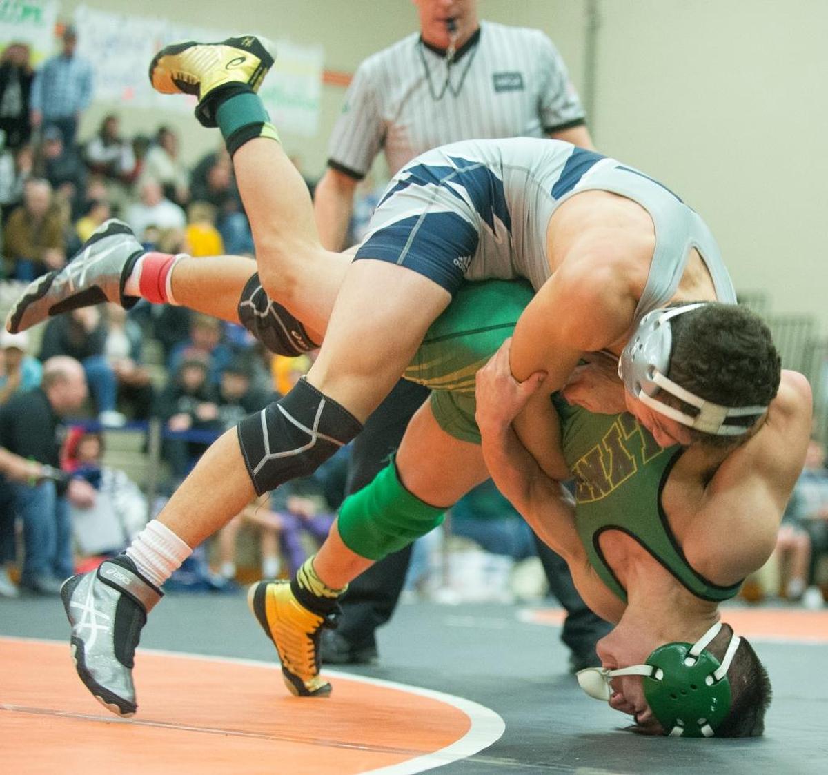 Squalicum's Jase Cooper, top, attempts a takedown on Lynden's Pablo Martinez on his way to winning the 120-pound championship match at the Battle at the Border wrestling tournament on Saturday, Dec. 9, in Blaine.