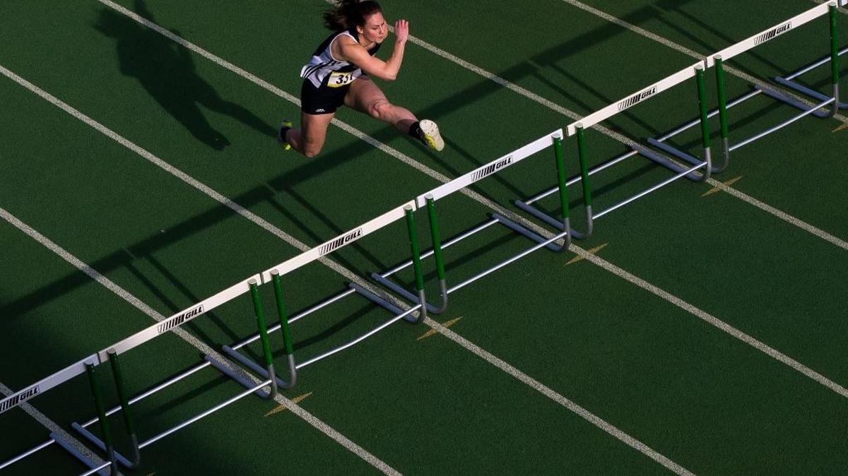 Lynden Christian's Hannah Rusnak clears a hurdle during the girls' 100 meter hurdles at the Bedlington Twilight Invitational track meet on Friday, March 25, at Lynden High School. Rusnak's time of 14.89 was a new meet record breaking the old record of 15.88 by nearly a second.