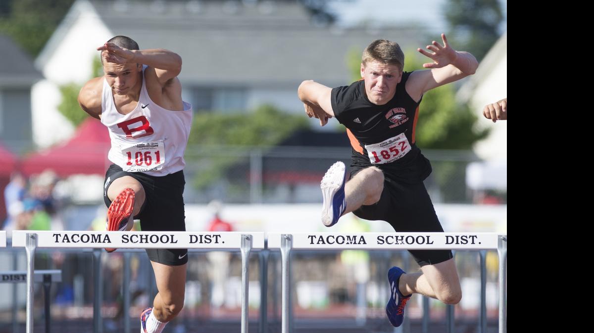 
Bellingham's Benjamin Doucette, left, races toward a second place finish in the 110-meter hurdles at the Class 2A Track and Field State Championships on Friday, May 29, at Mount Tahoma High School in Tacoma.
