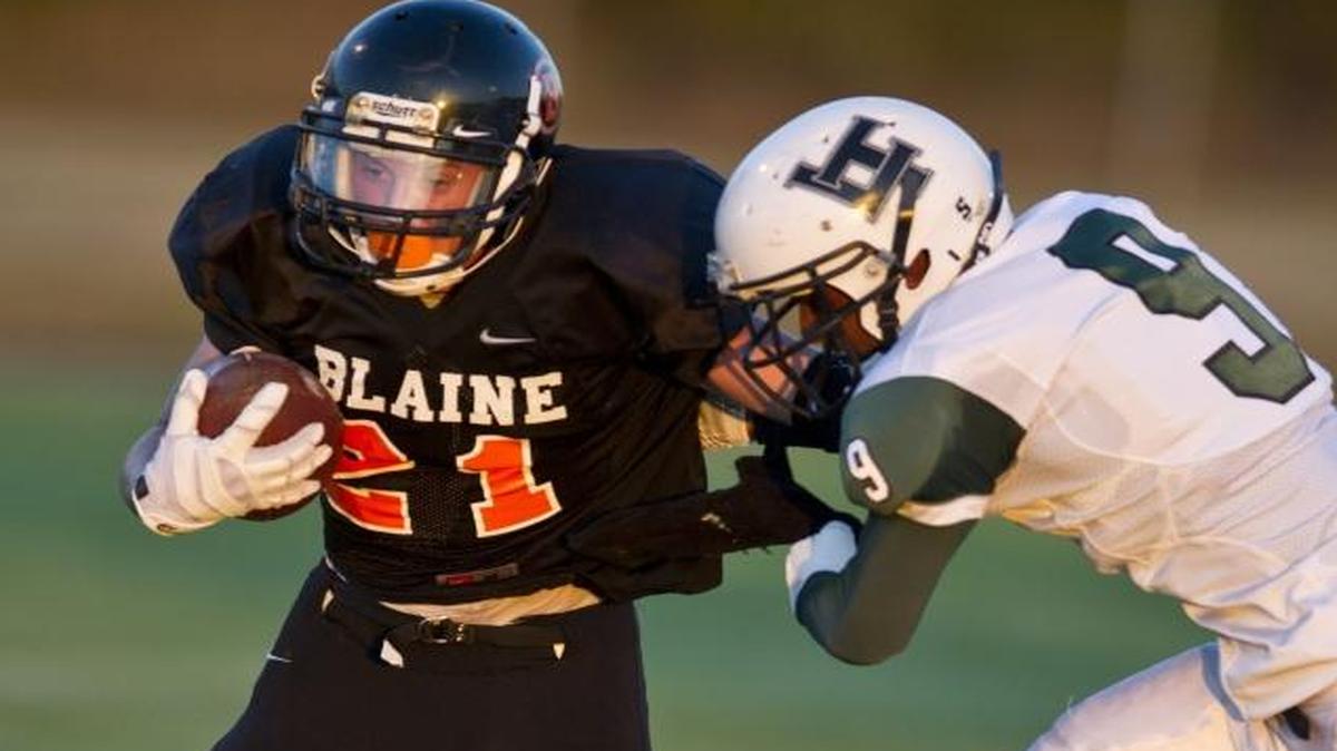 Blaine’s Cole Muder breaks a tackle by Joe Carter of Lord Tweedsmuir (B.C.) in a 2013 football game in Blaine. With the addition of Hermiston (Oregon) High School to the WIAA beginning in the fall of 2018, the WIAA set criteria for addressing such requests from out-of-state schools on a case-by-case basis, meaning Canadian schools could apply to join the Northwest Conference.