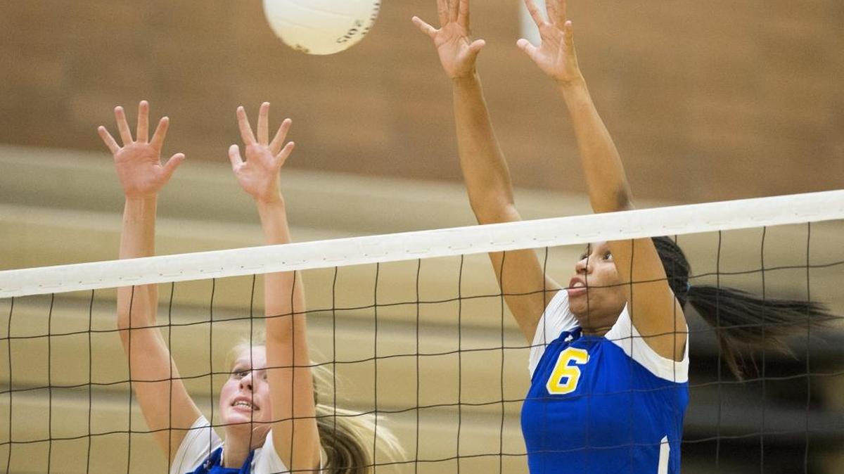 Ferndale’s Kaylyn Whipkey and Taryn Potter jump to block a shot by Sehome on Sept. 29.