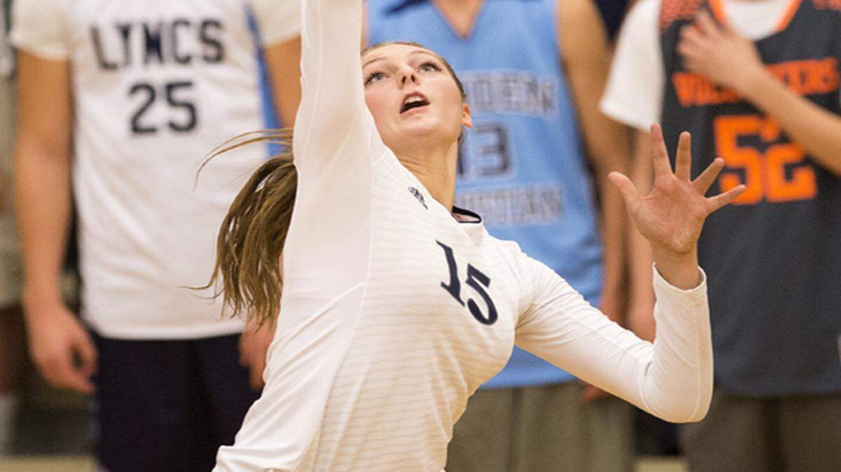 Lynden Christian's Kara Bajema spikes the ball against King's during the 1A Northwest District Volleyball Tournament at Lynden Christian High School on Oct. 29, 2014 in Lynden, Wash.