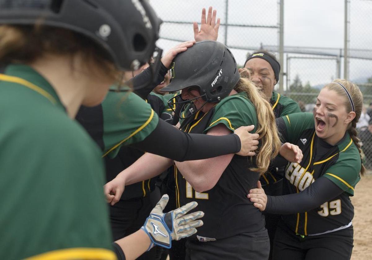 The Sehome softball team celebrates a run during the Class 2A Bi-District Tournament in Sedro-Woolley.