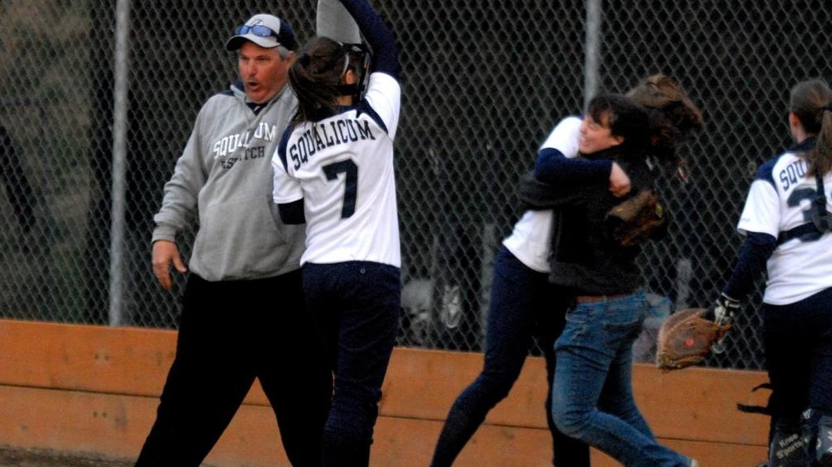 Squalicum head coach Rick Ellis high fives Emily Cyr as the Storm celebrates beating Blaine in April 2008. Ellis, who has coached the Bellingham softball team the past six year, announced he is stepping down.