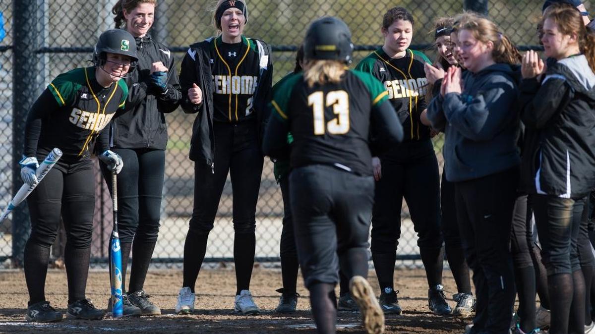 Sehome’s Carissa McDowell, center, is greeted by teammates after hitting a home run in the Mariners’ 10-0 victory over Bellingham.
