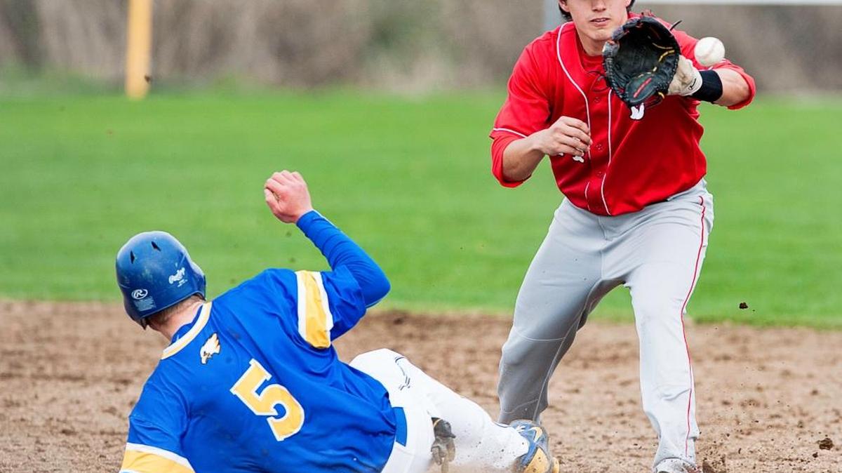 Bellingham shortstop Austin Shenton, right, fields a throw as Ferndale’s Kyler Brudwick (5) slides into second Monday, March, 30.