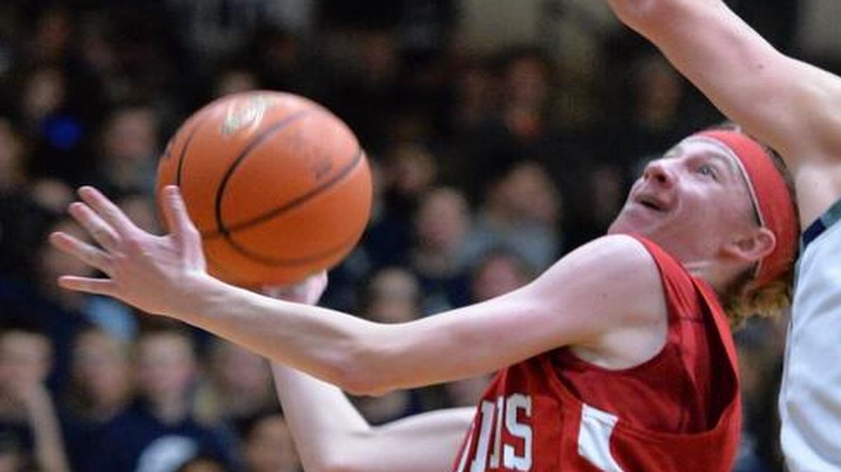 Bellingham’s Kyle Hofstetter drives around Squalicum’s Remington Wilcox in December 2013. Hofstetter has decided to attend and play basketball for Northwest University in Kirkland.