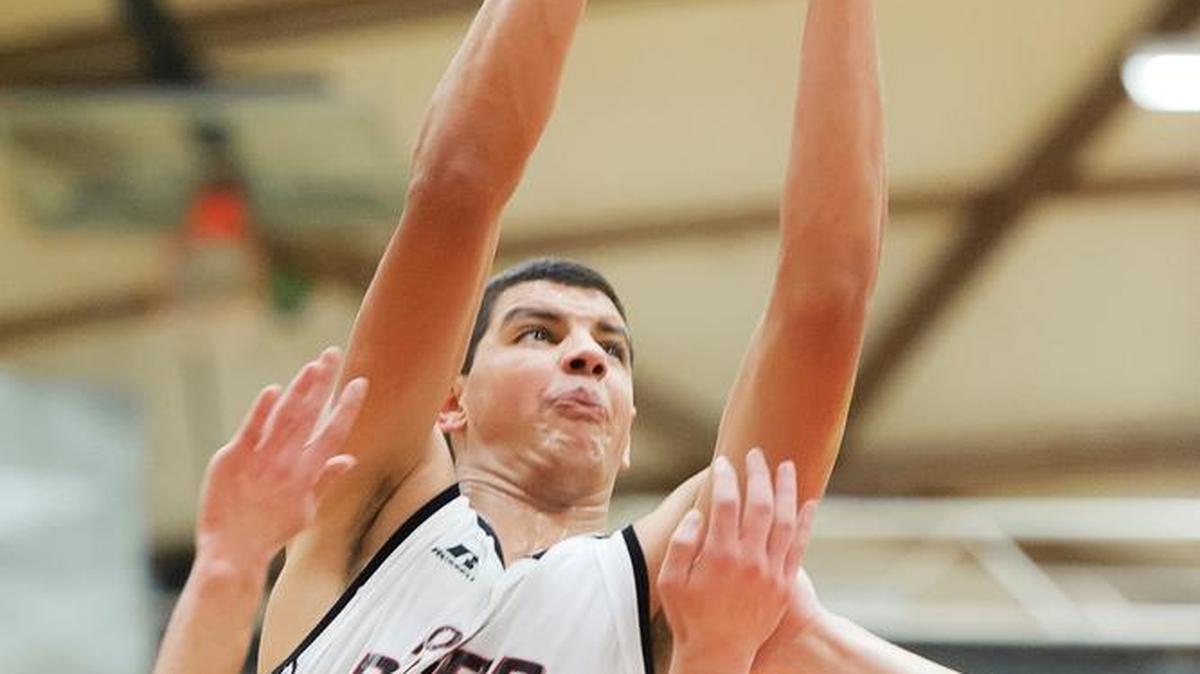 Mount Baker’s Timothy Soares shoots over Sultan’s Ben Biddle, left, and Josiah Cotterill during the second quarter in the first round of the Class 1A Northwest District Tournament Monday, Feb. 8.