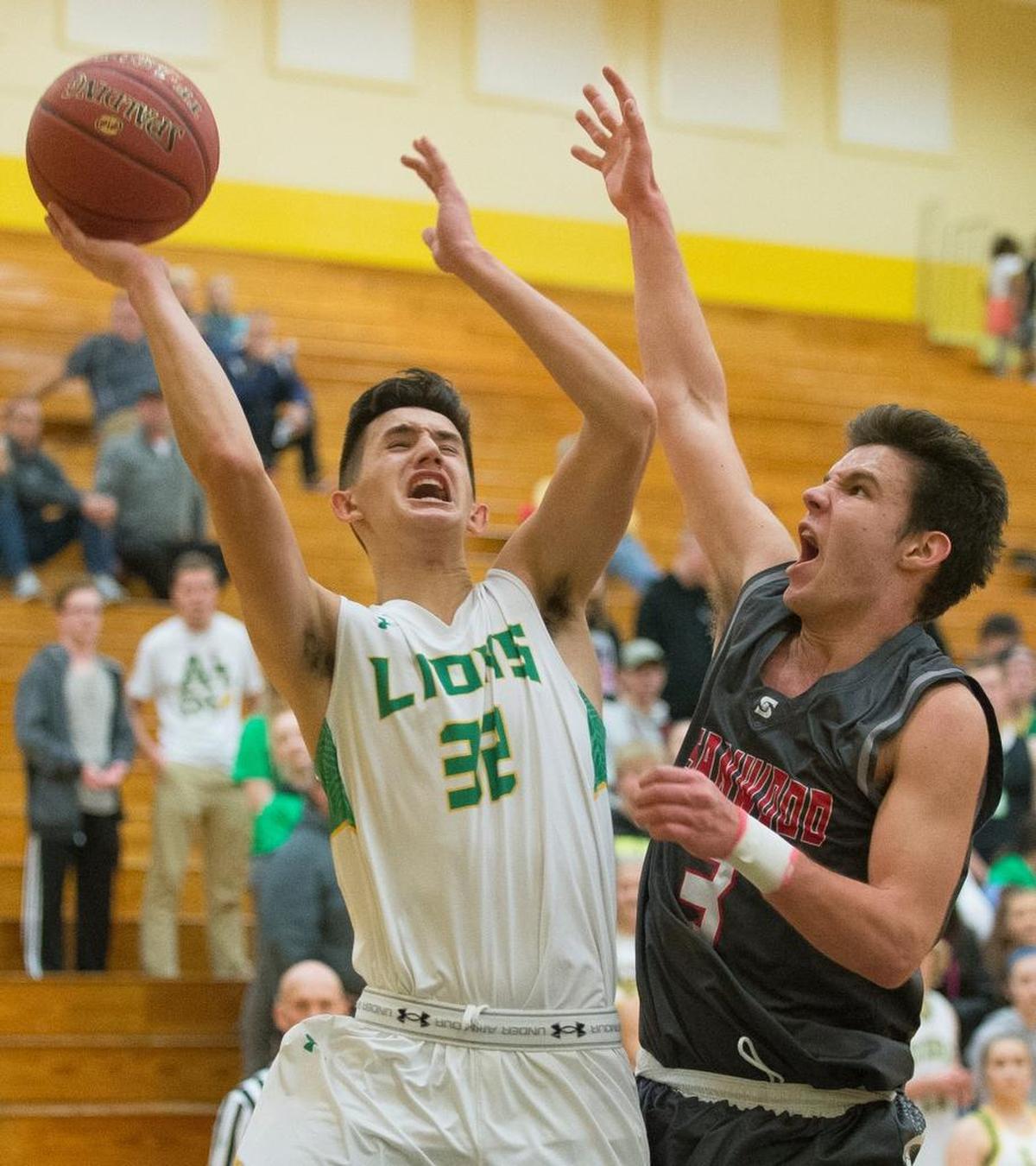 Lynden’s Christian Zamora, left, is fouled by Stanwood’s Matt Vail on Tuesday, Nov. 28, at Lynden High School.