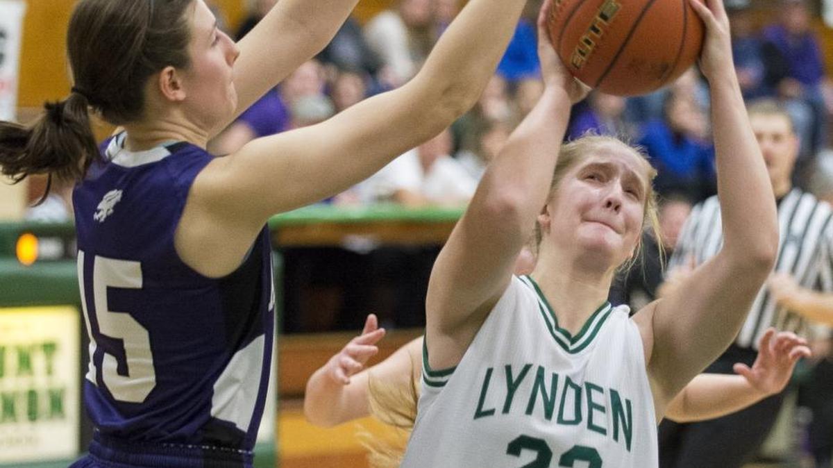 Lynden’s Elisa Kooiman drives toward the basket past Anacortes’ Clare Martin on Friday, Feb. 19, in Mount Vernon.