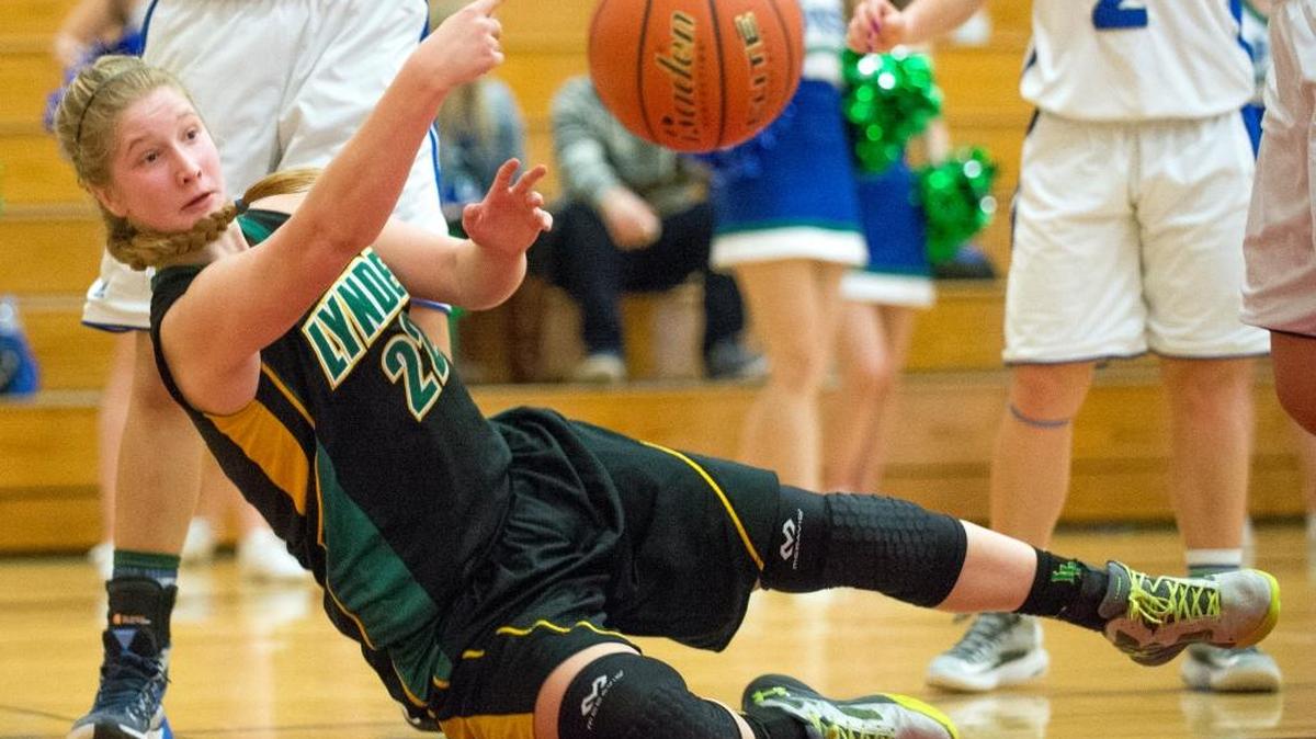 Lynden’s Elisa Kooiman passes the ball to a teammate as she falls out of bounds during a 67-39 victory over Liberty on Saturday, Feb. 27, at Renton High School.