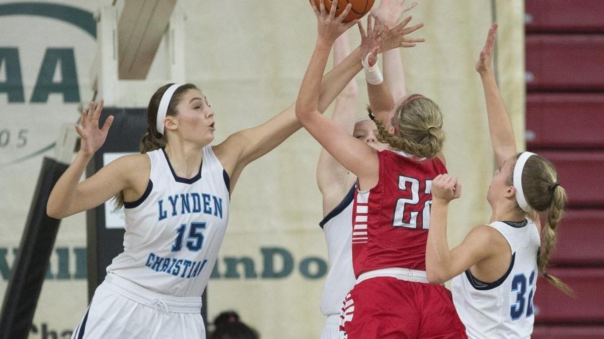Lynden Christian’s Kara Bajema (15) attempts to block a shot by King’s Anna Parker during the Class 1A Girls’ Basketball State Championship game March 5 at the Yakima Valley SunDome. Bajema has been selected the Associated Press Class 1A Player of the Year.