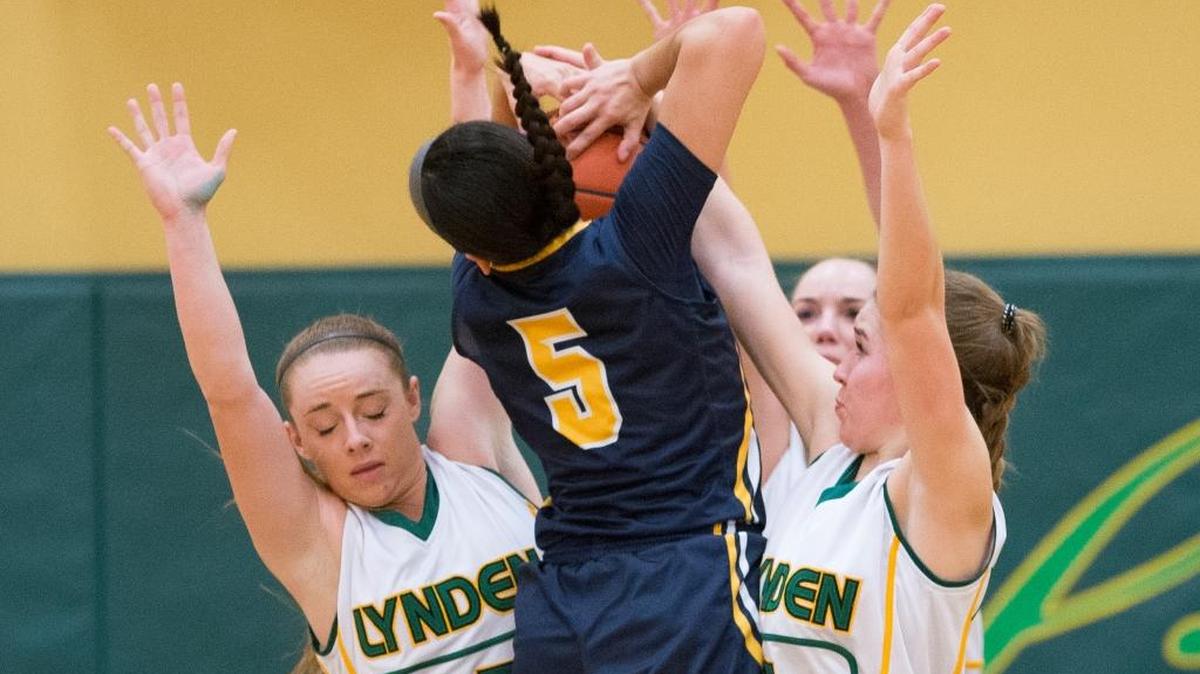 Lynden's Emily Holt, left, and Jasmyne Neria, right, block a shot by Burlington-Edison's Tyra Lopez on Tuesday, Jan. 26, at Lynden High School. Lynden lost to Burlington-Edison 69-46.
