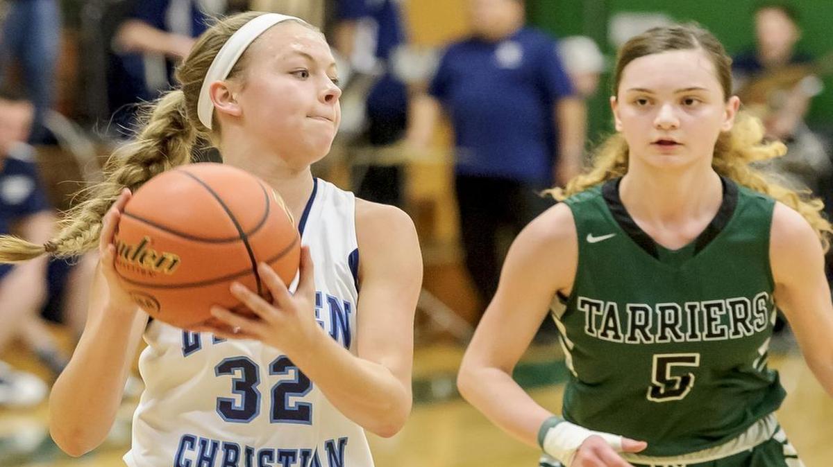 Lynden Christian's Avery Dykstra (32) passes to an open team mate during the second quarter as Charles Wright Academy's Majestic Moler (5) attacks in the 1A state regionals on Friday, Feb. 26, at Mount Vernon High School. Dykstra scored 4 points as Lynden Christian defeated Charles Wright 72-34to advance in the playoffs.