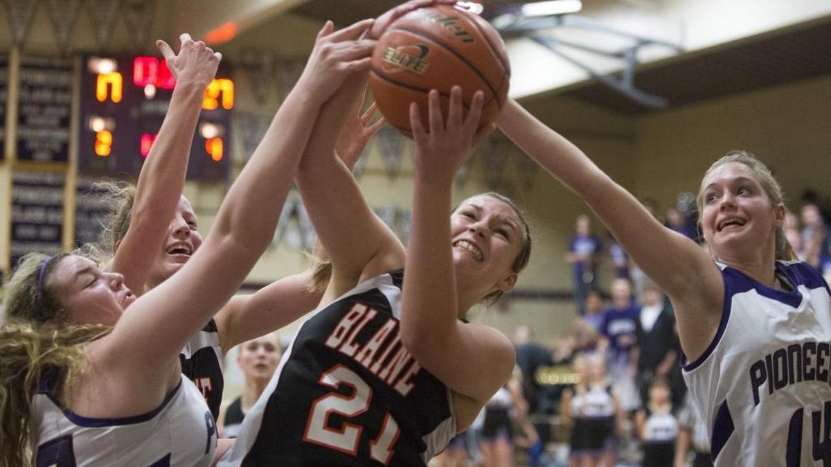 Blaine’s Kjirstin Larson grabs a rebound between Nooksack Valley’s Payton Linville and Emilia Gimmaka Feb. 6.