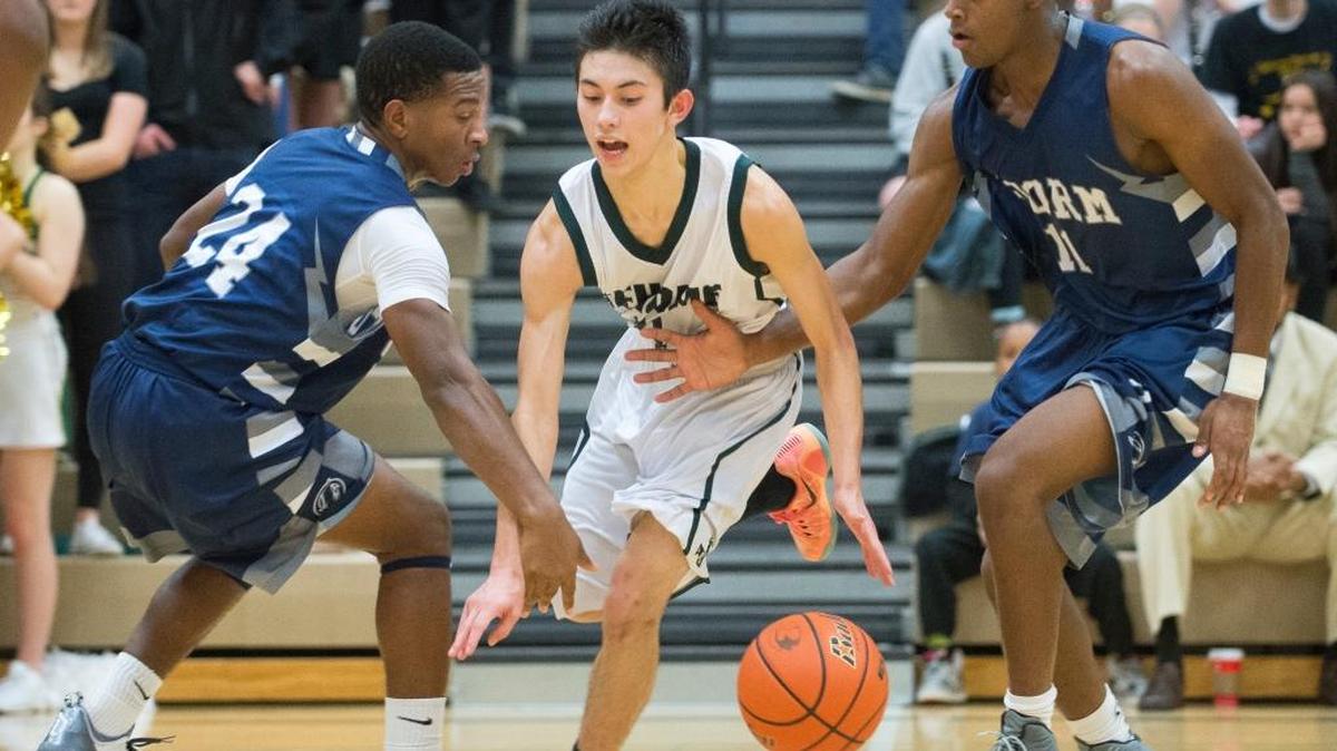 Squalicum's Damek Mitchell, left, slaps the ball away from Sehome's Jaren Tilley toward teammate Josiah Westbrook, right, on Tuesday, Dec. 8, at Sehome High School.
