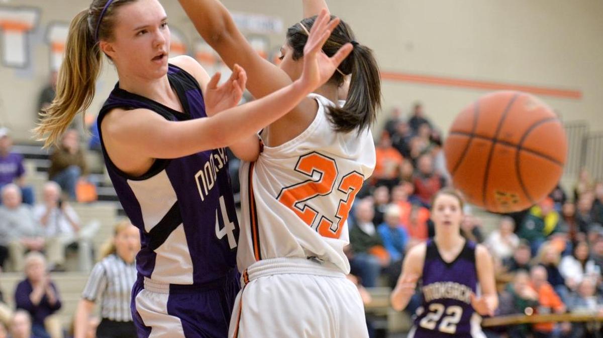 Nooksack Valley's Brianna Turner throws a pass around Blaine's Mandy Hayes in the first round of the Class 1A Northwest District Girls' Basketball Tournament on Tuesday, Feb. 11, 2014 in Blaine.