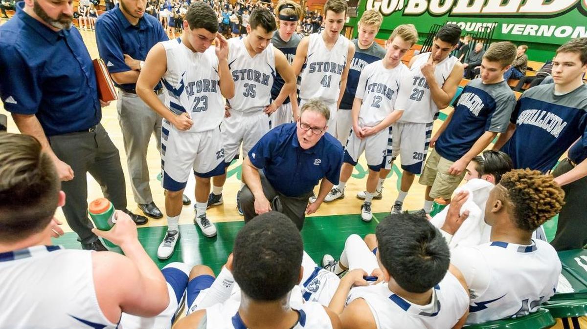 Coach David Dickson, center, talks to the Squalicum basketball team during a timeout against Shorecrest during the second quarter Saturday, Feb. 20, at Mount Vernon High School.