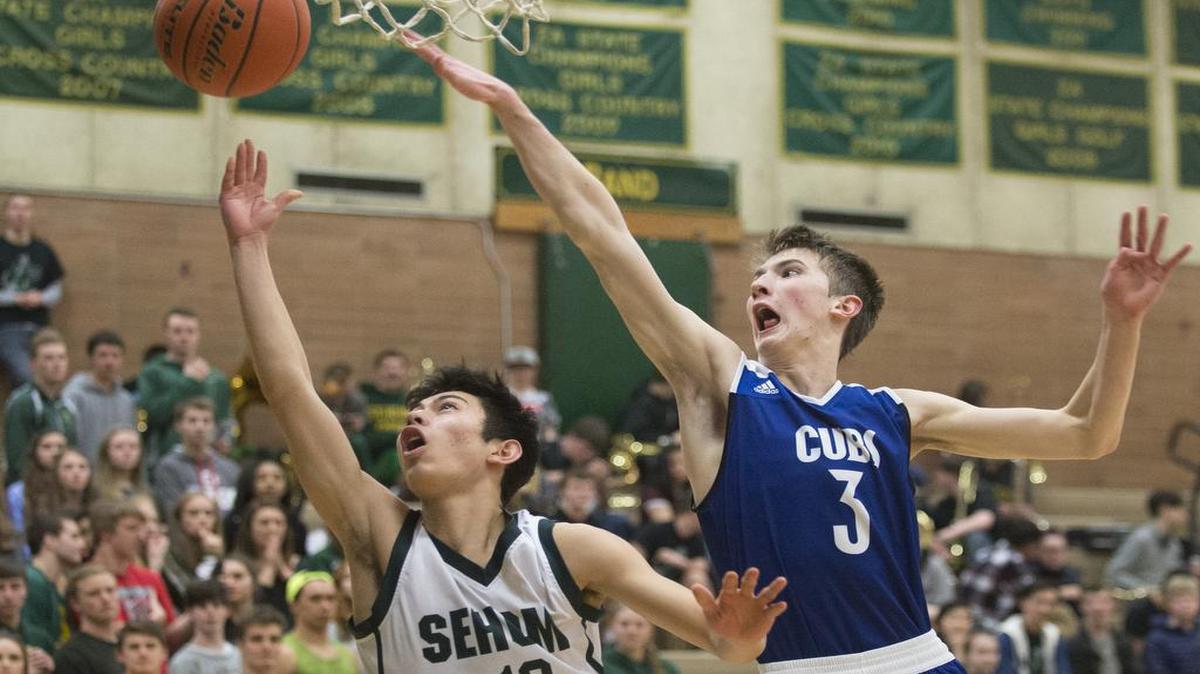 Sehome's Jaren Tilley shoots and scores around the outstretched arm of Sedro-Woolley's Cade Isakson on Friday, Feb. 10, at Sehome High School.